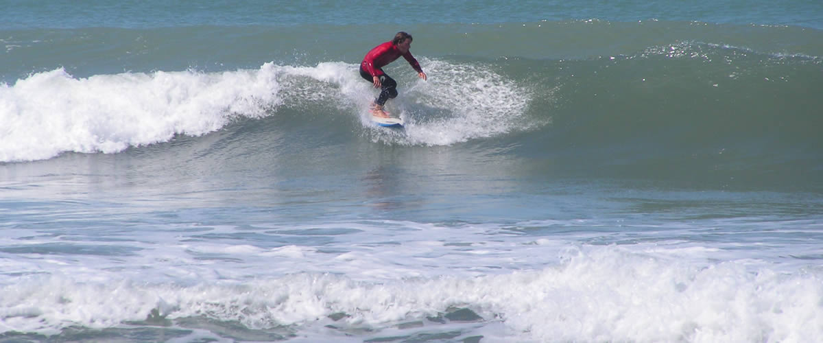 Surfer riding the waves at Bude, North Cornwall